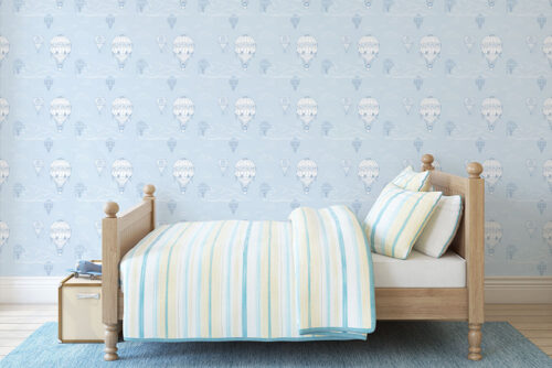 Blue background with white hot air balloon pattern printed on peel and stick wallpaper in America