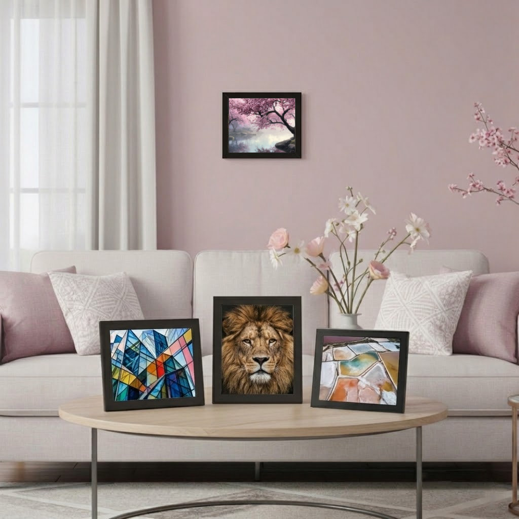 Photo prints with black frames on living room table and wall