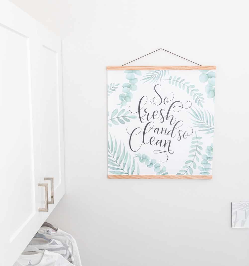 Decorative word art printed on canvas and mounted in laundry room with magnetic wooden hangers